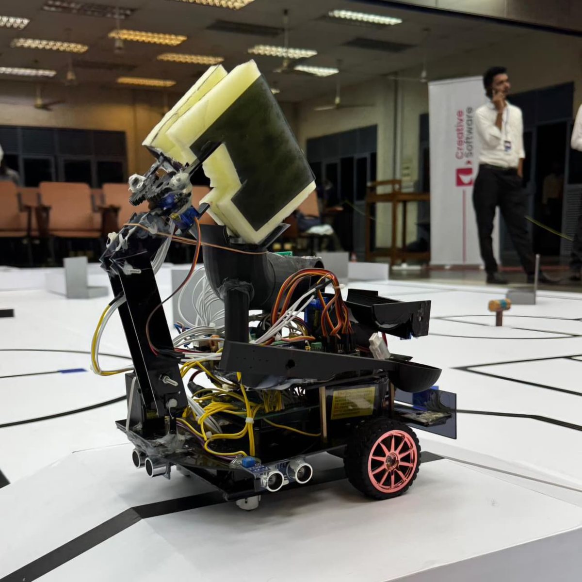 Team Botato's Xbotix 2025 robot with a gripper arm on the arena